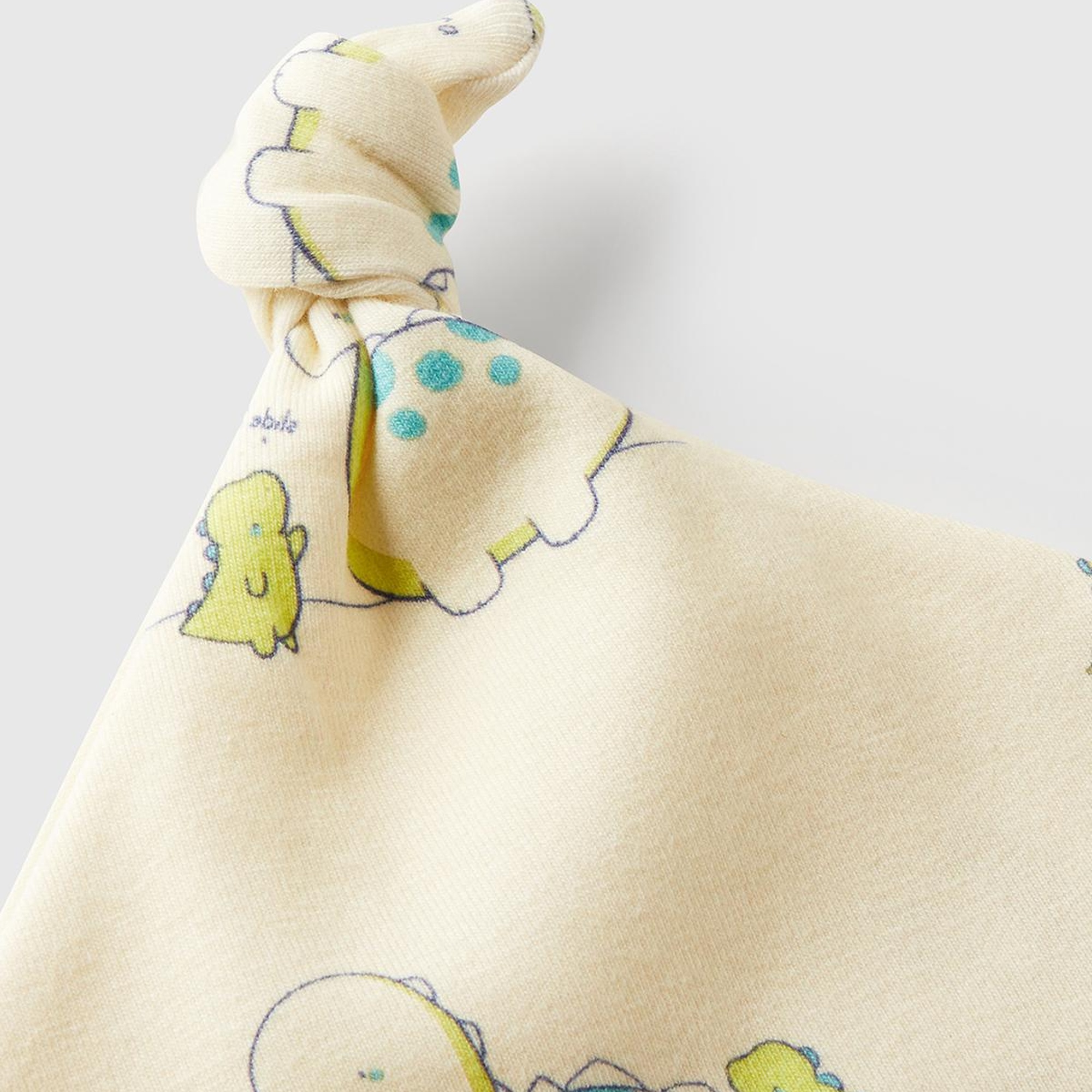 Bebek Ekru Tamamı Baskılı Ucu Düğüm Görünümlü Jarse Şapka